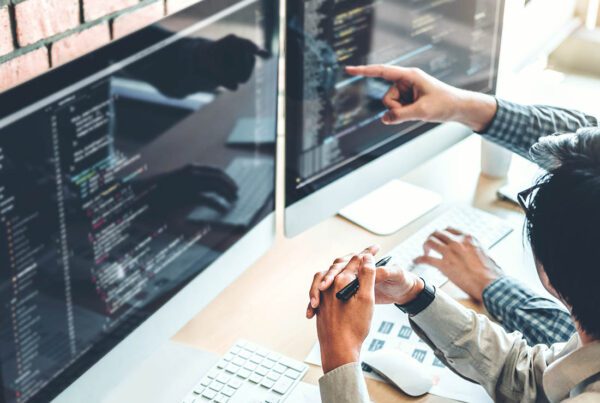 Cyber Liability - Group of Employees Working on Code to Prevent Cyber Attacks