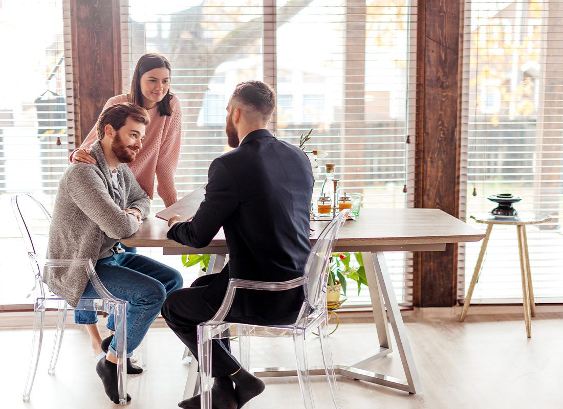 Home Warranty Protection - Couple Meeting With a Home Warranty Advisor in Their Home While Sitting at Their Kitchen Table